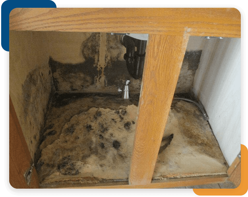 A closeup look under the sink with wooden brackets